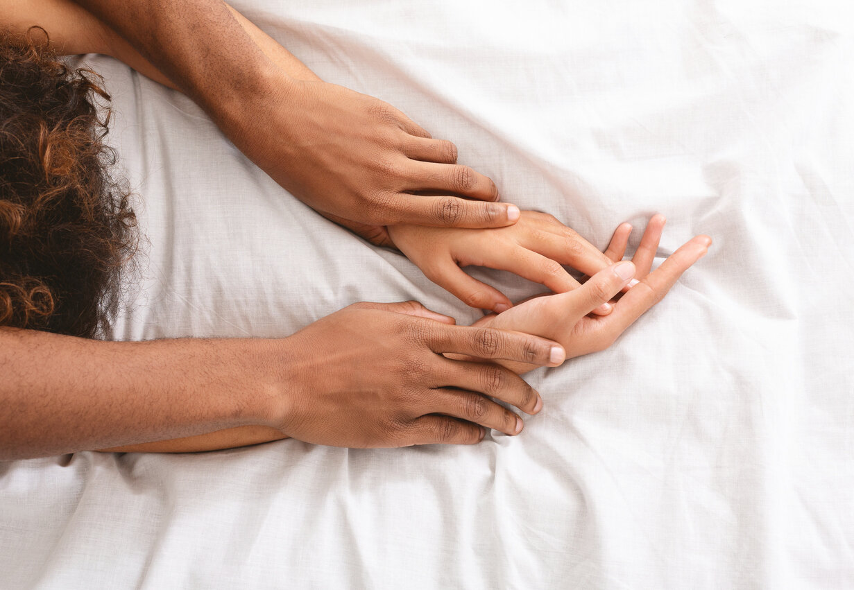 Man and woman hands intimacy on bed