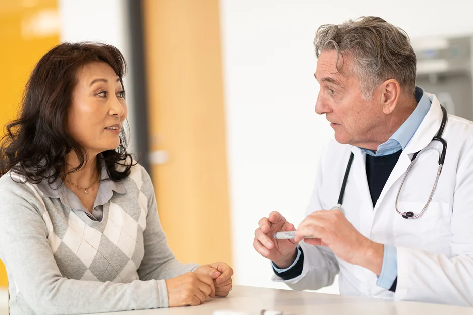 Asian woman consults her male doctor with regards to using semaglutide injection