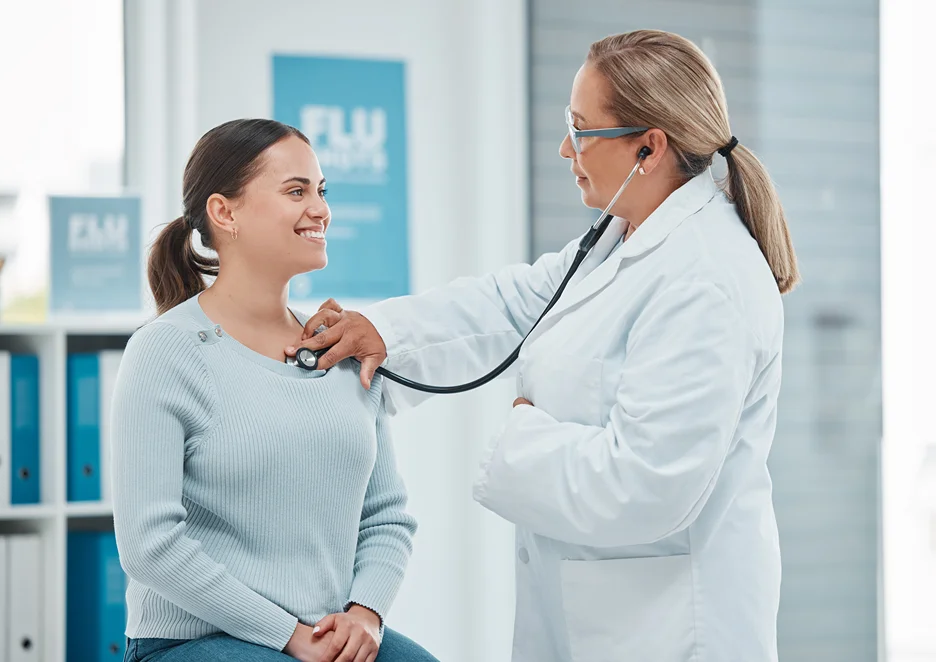 a doctor checks her patient's heart health